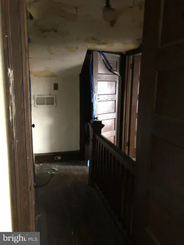 a view of an empty room with wooden walls