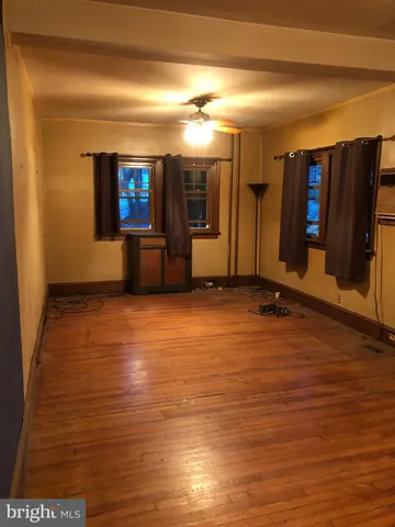 an empty room with wooden floor