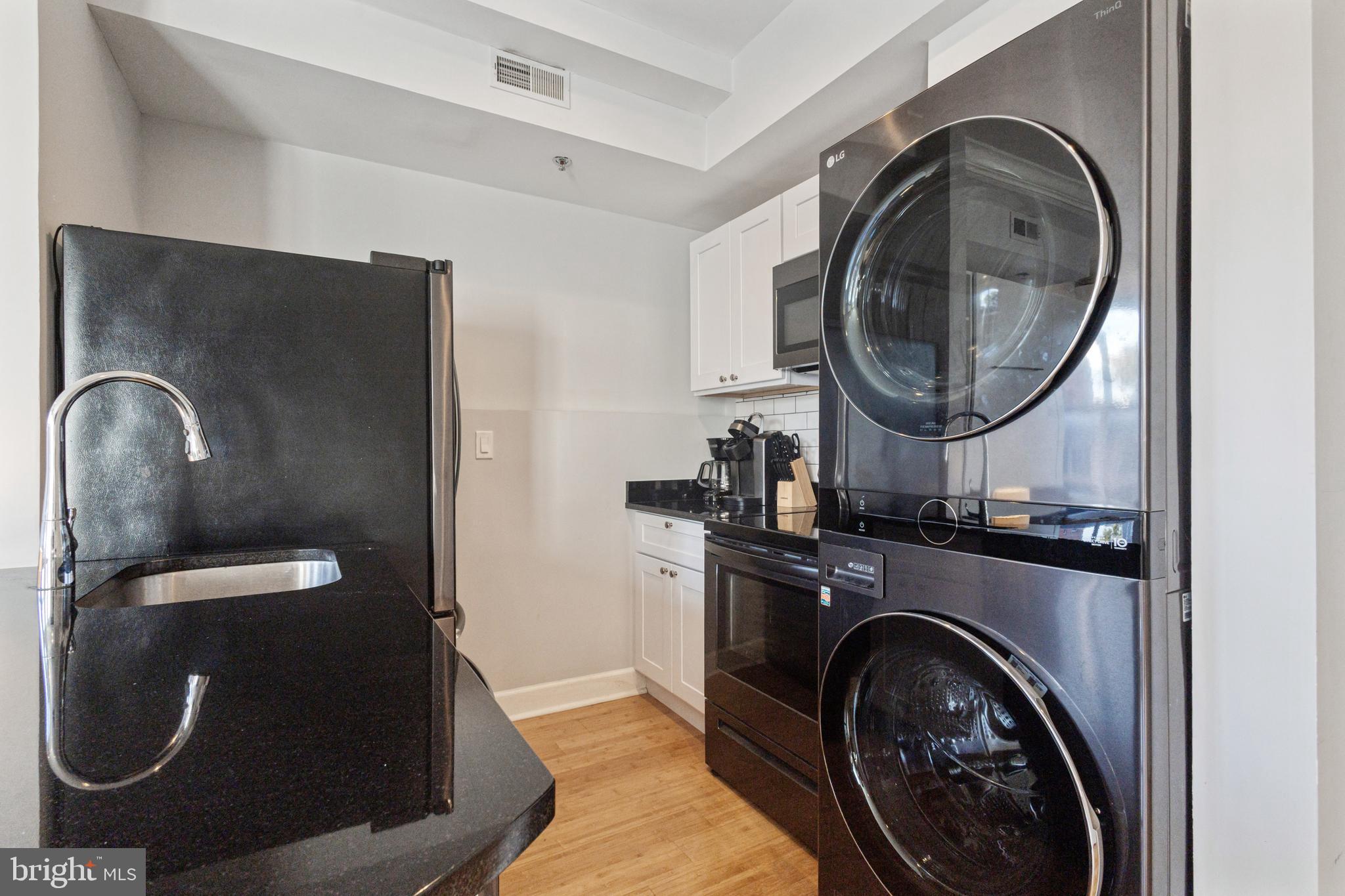 180 Main Street, Unit 202 Annapolis, MD 21401 - Photo 5 of 15 a utility room with sink dryer and washer