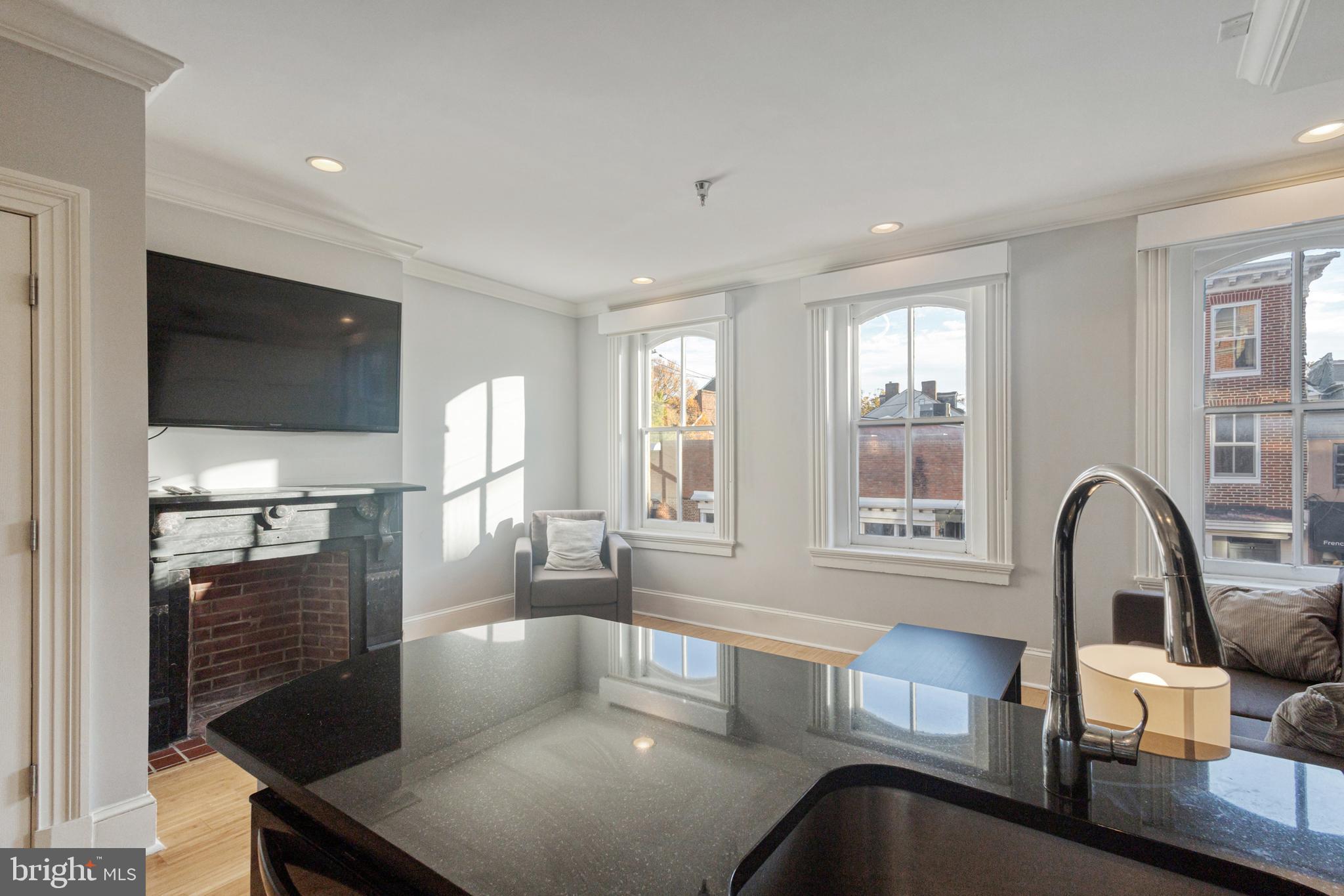 180 Main Street, Unit 202 Annapolis, MD 21401 - Photo 6 of 15 a living room with furniture and a flat screen tv