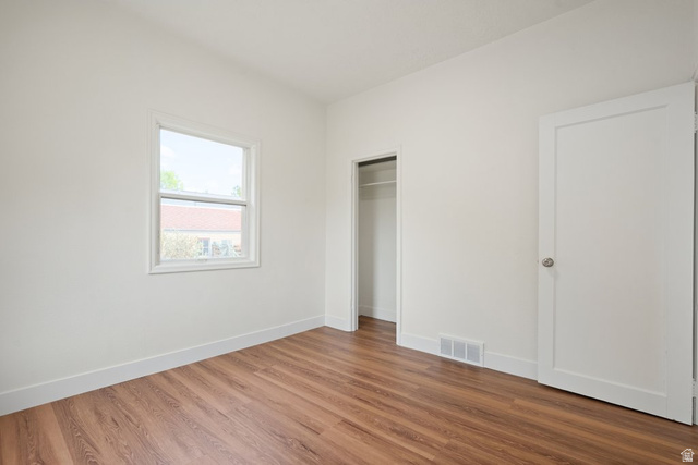 673 East 700 South Springville, UT 84663 - Photo 21 of 43 Room featuring wood-finish flooring, white baseboards, a white window frame, and a white interior door