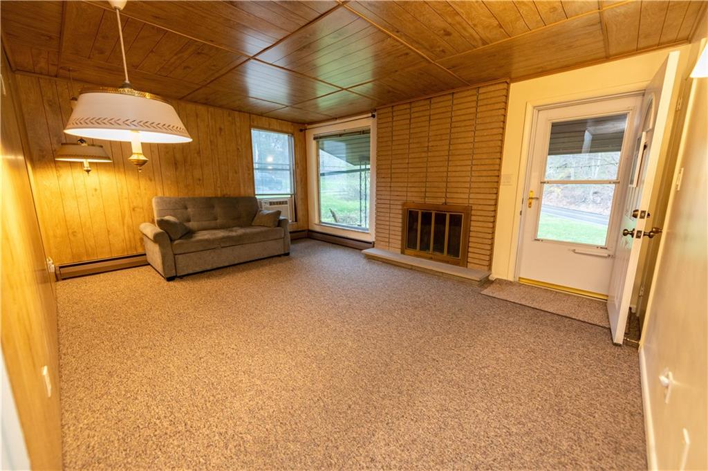 1041 Anderson Road Pittsburgh, PA 15209 - Photo 9 of 41 a living room with furniture a fireplace and a flat screen tv