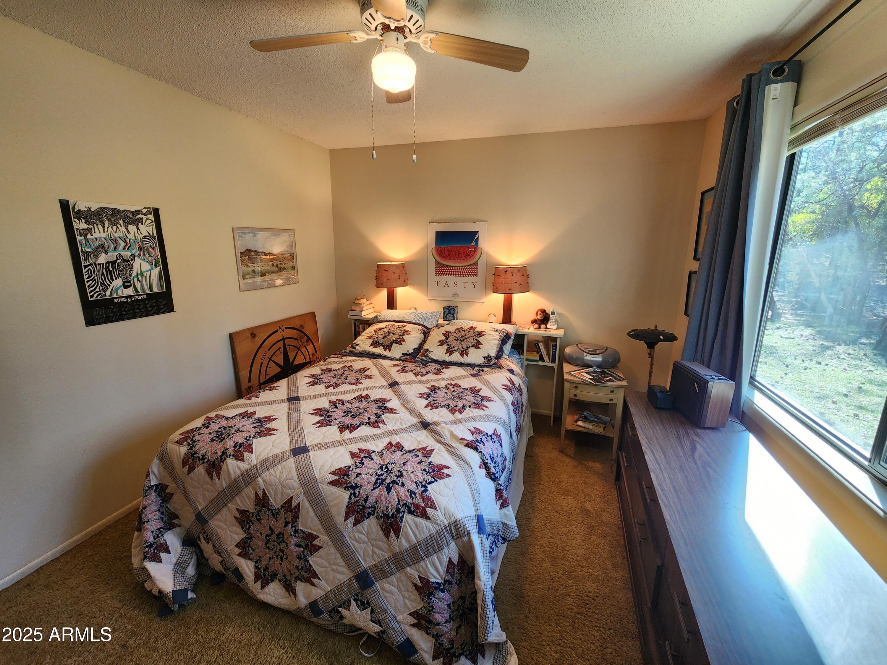 247 West Diamond Road Payson, AZ 85541 - Photo 21 of 42 a bedroom with a bed and a chandelier