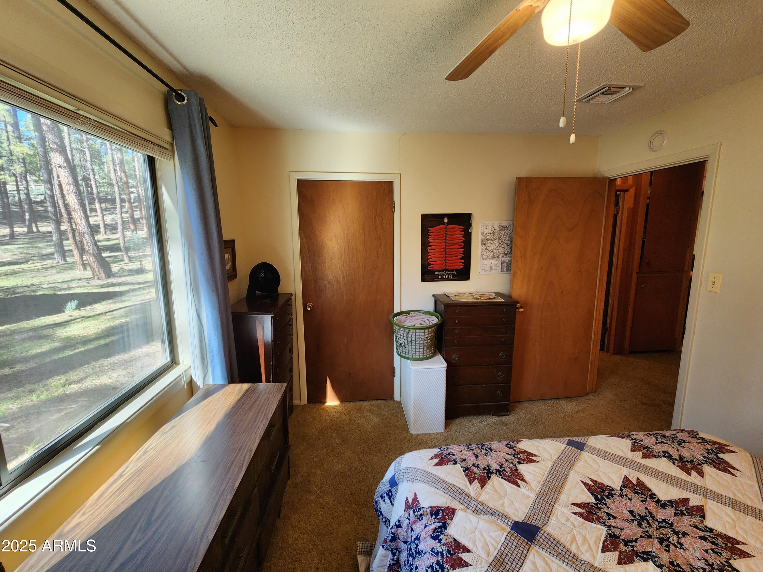 247 West Diamond Road Payson, AZ 85541 - Photo 22 of 42 a bedroom with a bed and a chandelier