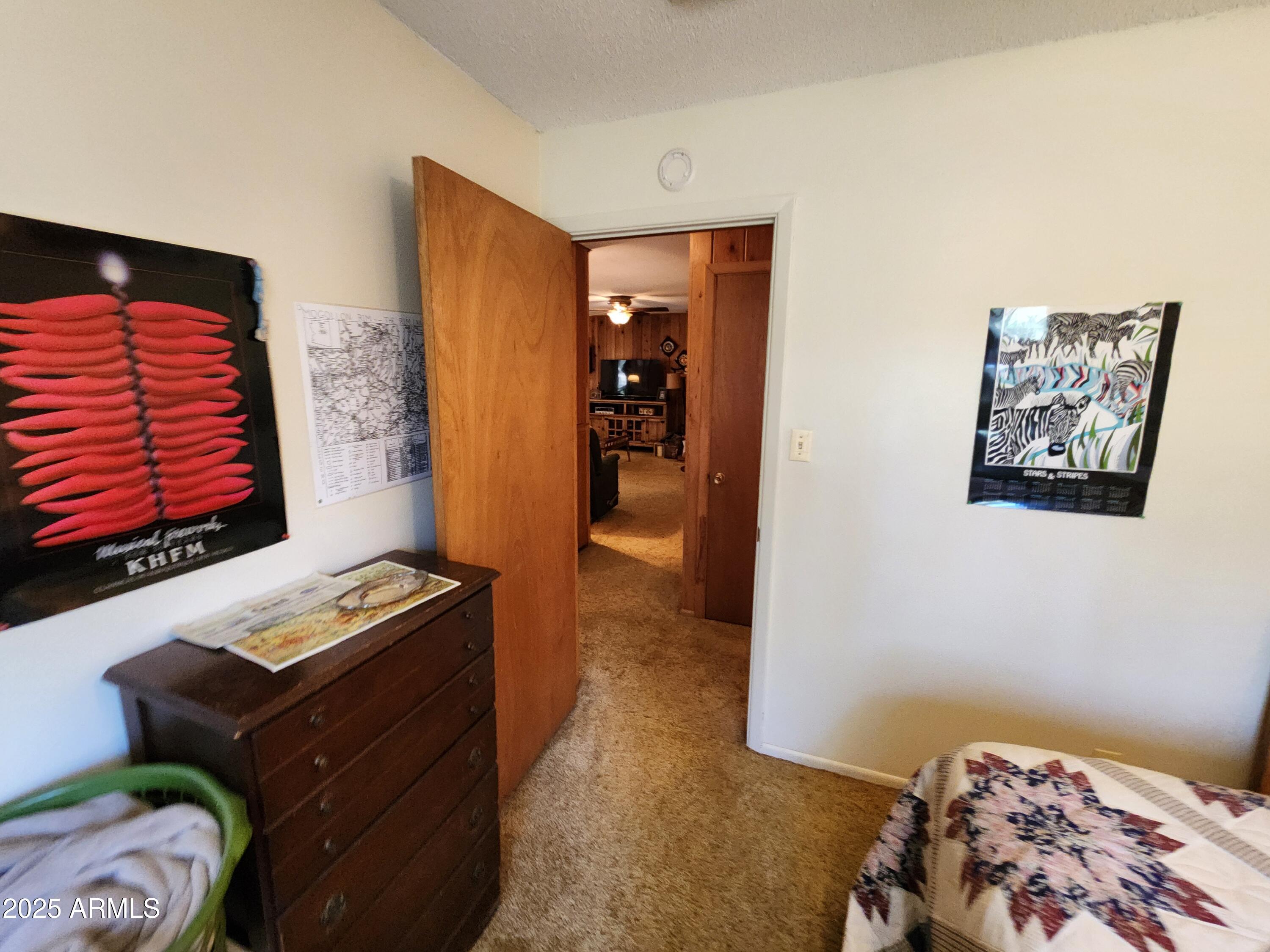247 West Diamond Road Payson, AZ 85541 - Photo 23 of 42 a bedroom with a bed and wooden floor