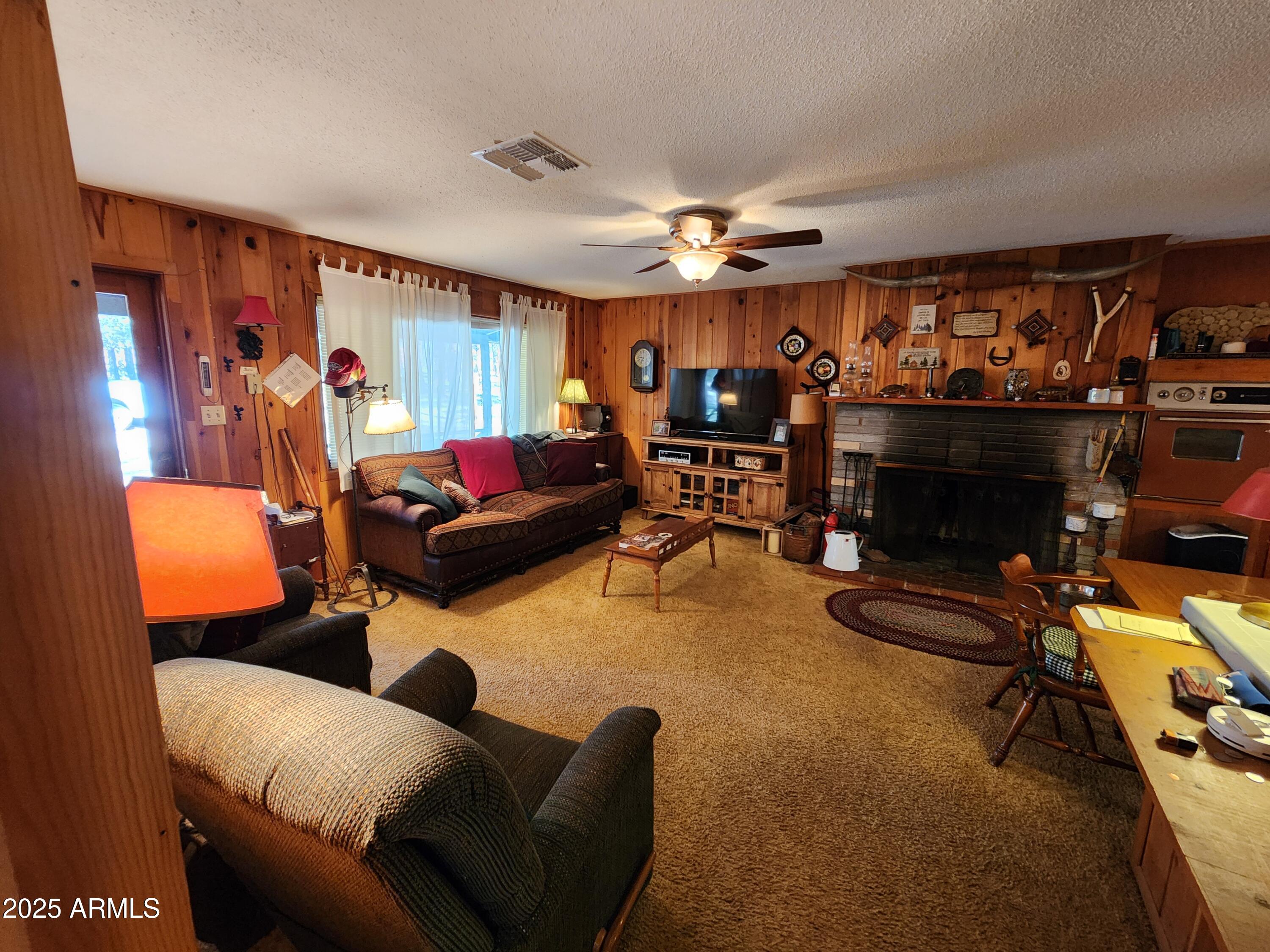 247 West Diamond Road Payson, AZ 85541 - Photo 25 of 42 a living room with furniture a flat screen tv and a fireplace