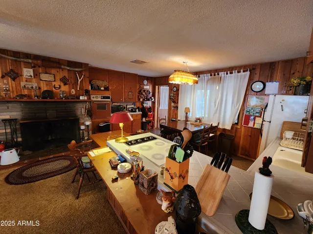 a kitchen with sink stove and refrigerator