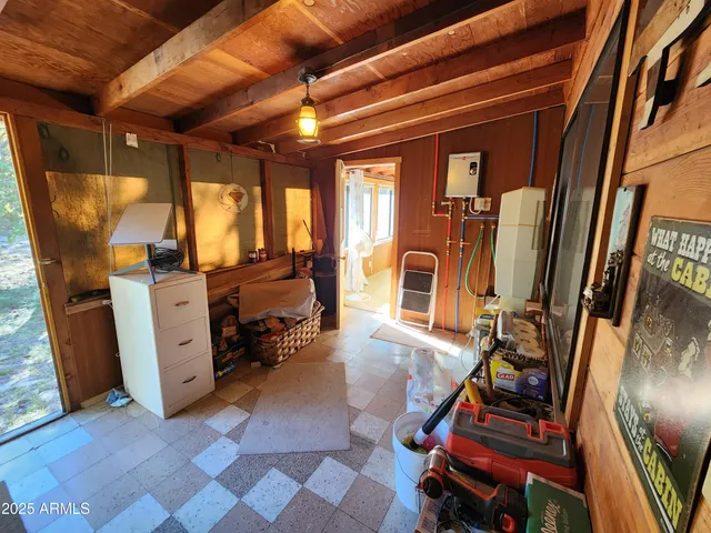 a bed sitting in a bedroom next to a window