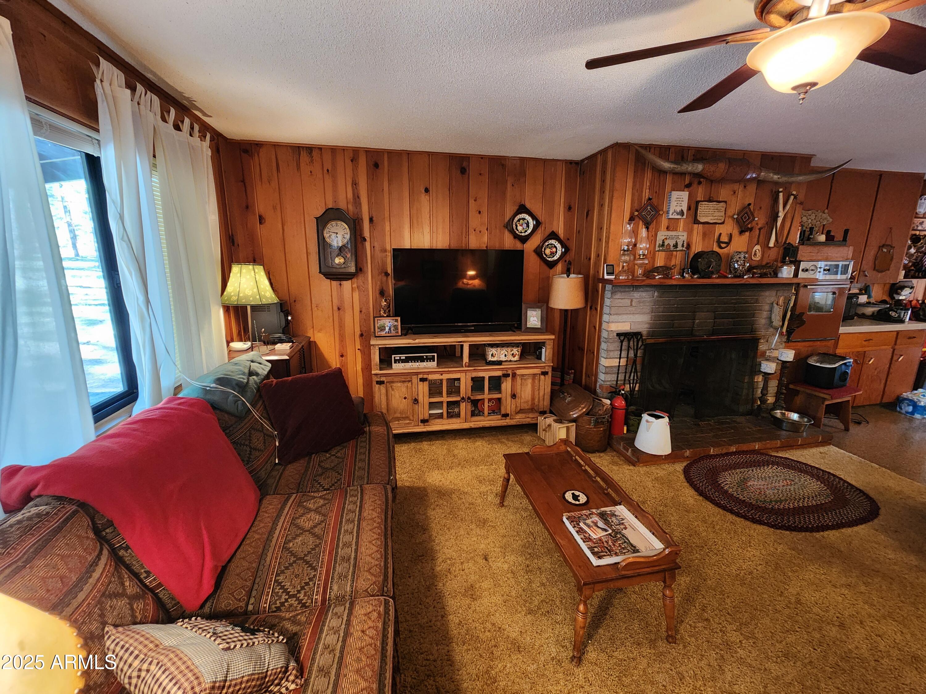 247 West Diamond Road Payson, AZ 85541 - Photo 3 of 42 a living room with furniture a fireplace and a flat screen tv
