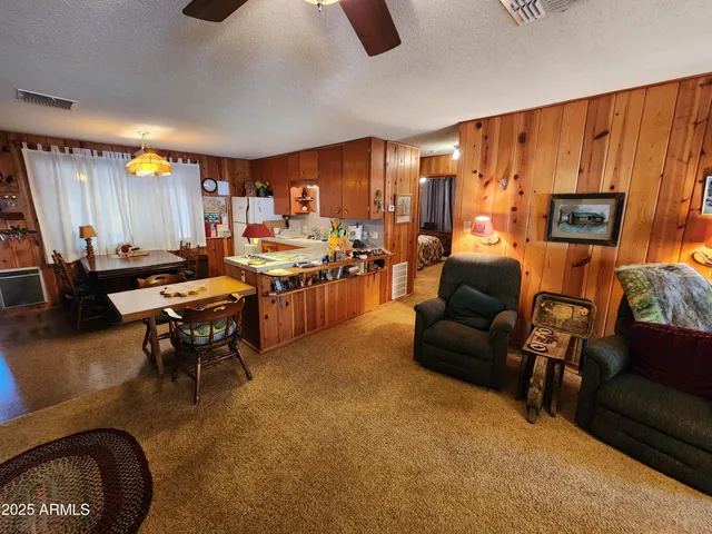 a living room with fireplace furniture and a large window