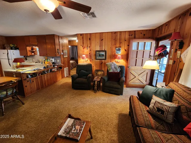 a living room with furniture a rug and a chandelier