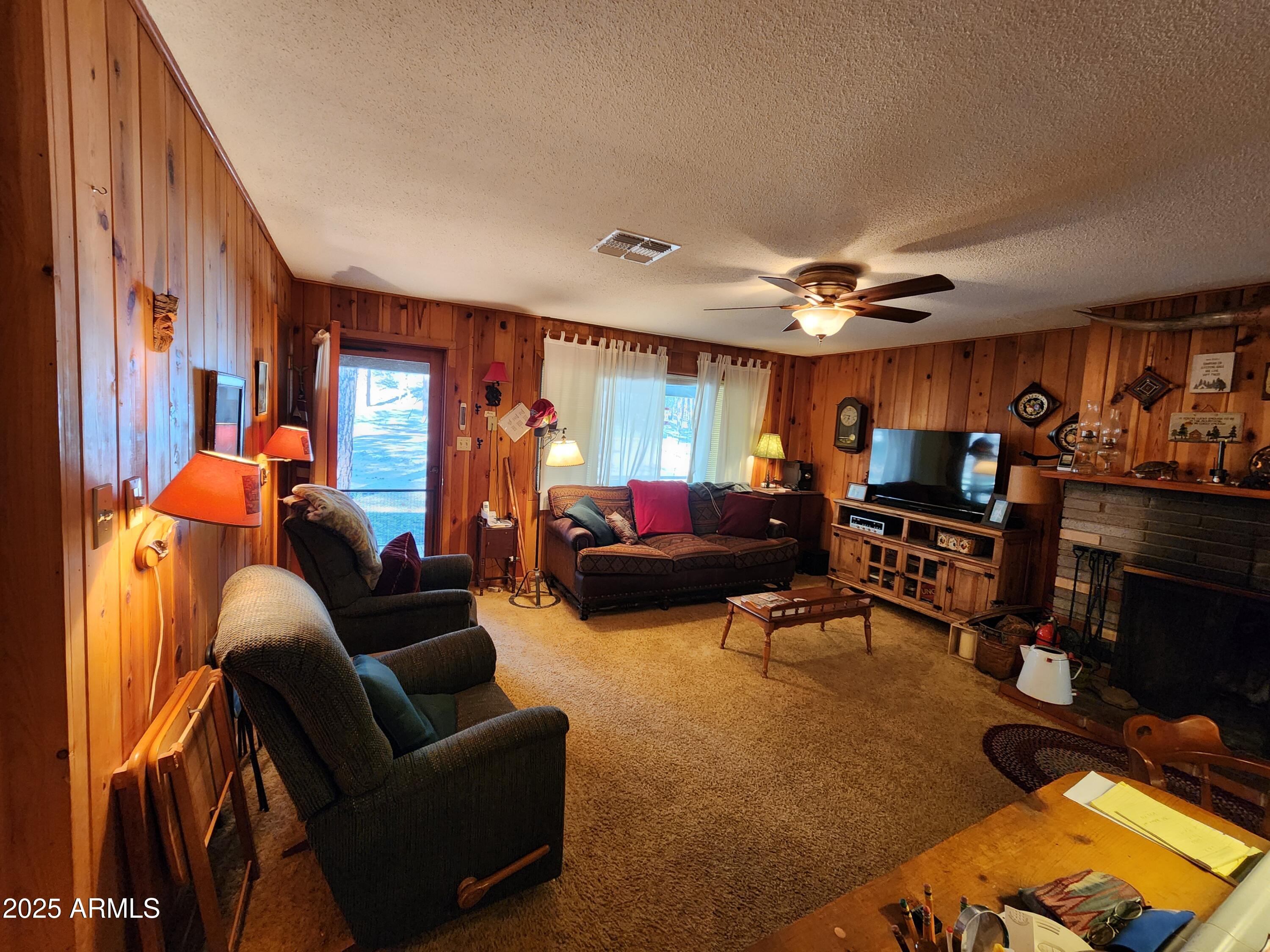 247 West Diamond Road Payson, AZ 85541 - Photo 10 of 42 a living room with furniture a fireplace and a flat screen tv