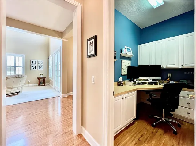 a kitchen with a sink cabinets and wooden floor