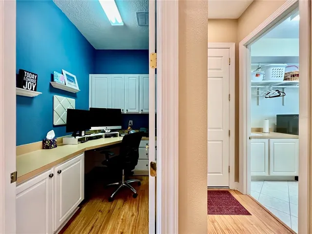 a view of a workspace with furniture and wooden floor