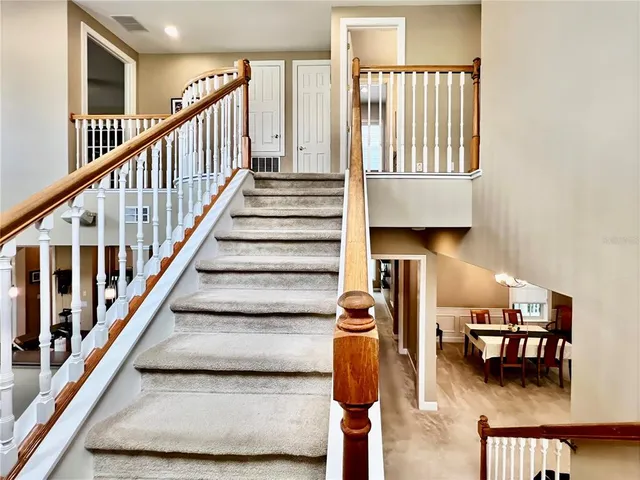 a view of entryway and hall with dining room