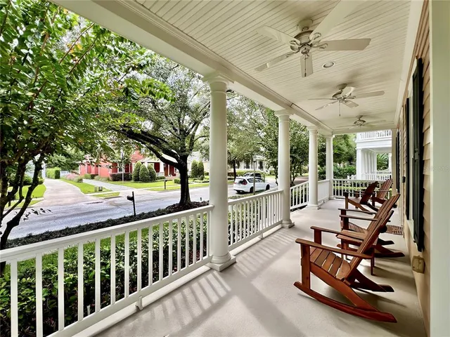 a view of a porch with furniture and a backyard