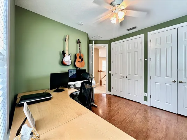 a view of a workspace with furniture and a window