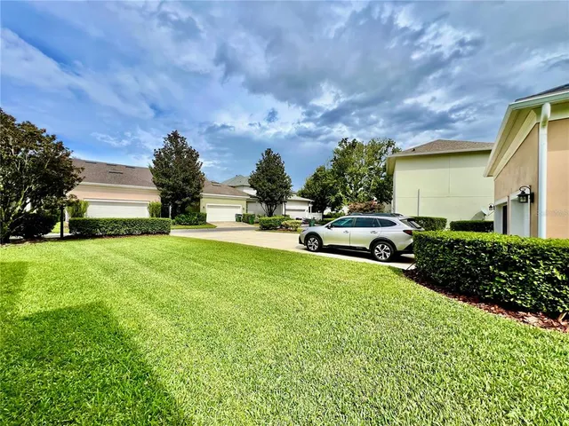 a view of an house with backyard space and garden