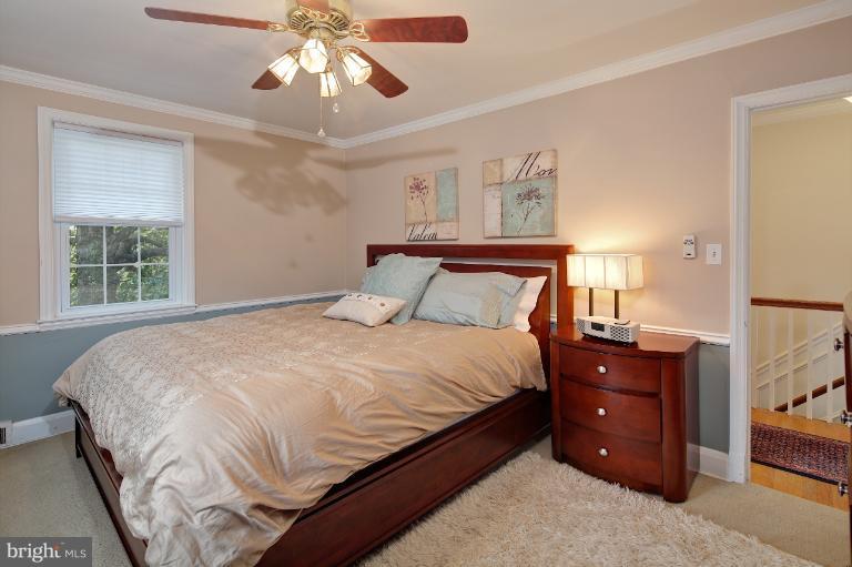 418 Overbrook Road Baltimore, MD 21212 - Photo 25 of 30 a bedroom with a bed and a chandelier