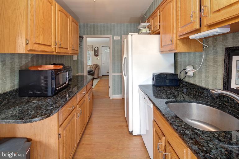 418 Overbrook Road Baltimore, MD 21212 - Photo 7 of 30 a kitchen with granite countertop a sink stove and refrigerator