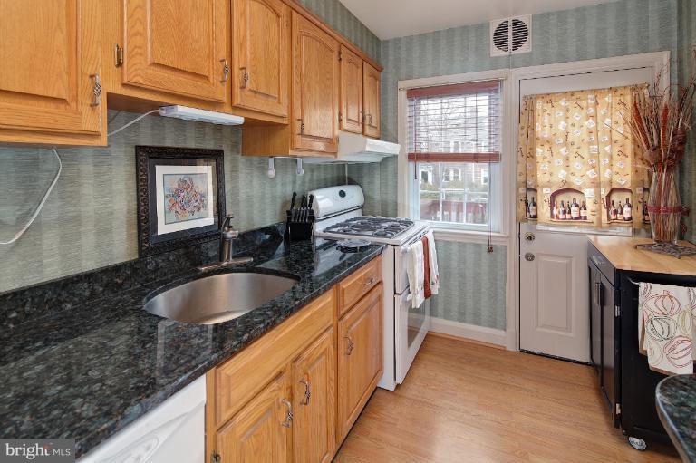 418 Overbrook Road Baltimore, MD 21212 - Photo 8 of 30 a kitchen with granite countertop a sink stove and cabinets