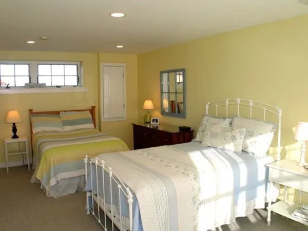 a bedroom with two beds and painted walls
