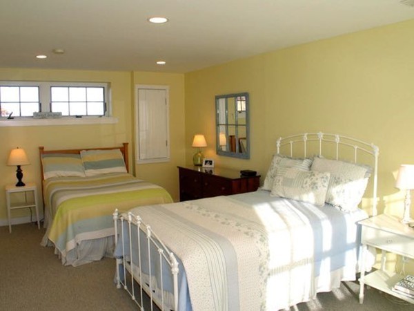 40 Lighthouse Road Aquinnah, MA 02535 - Photo 9 of 25 a bedroom with two beds and painted walls