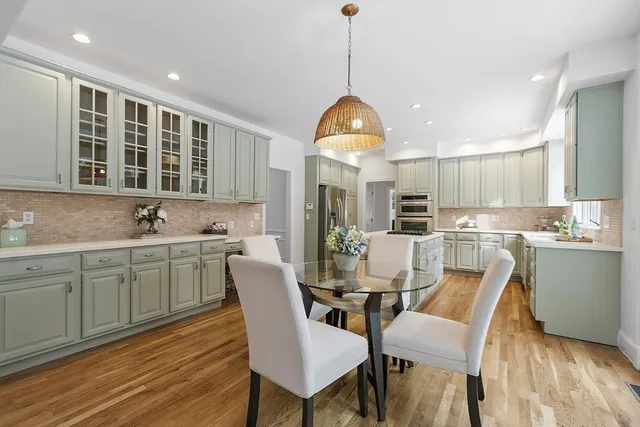 a kitchen with a table chairs sink and cabinets