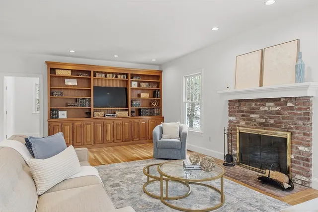 a living room with furniture a rug and a fireplace