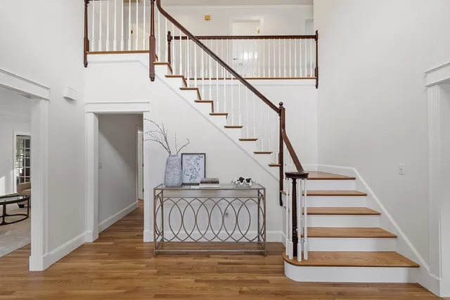 a view of entryway and hall with wooden floor