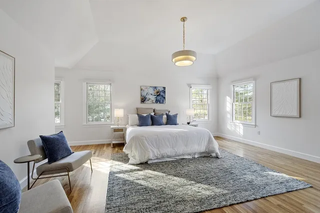 a spacious bedroom with a bed and window