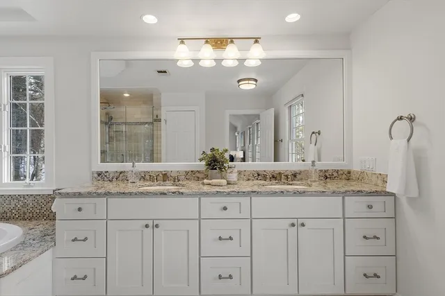 a bathroom with a granite countertop sink mirror and double