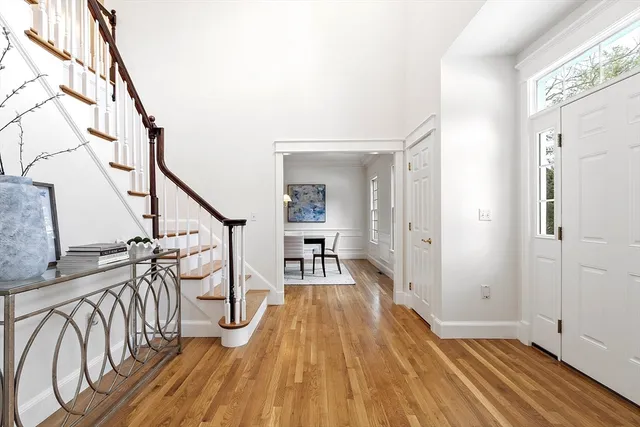 a view of hallway with wooden floor and stairs