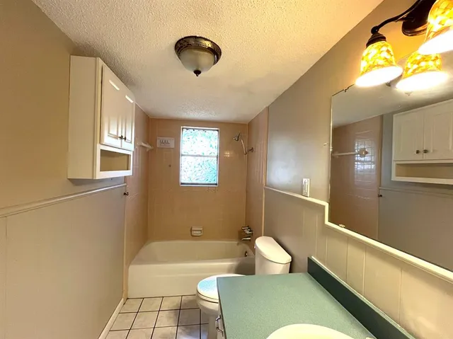 a bathroom with a sink a toilet and bathtub