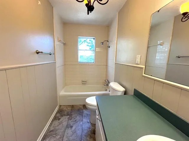 a bathroom with a bathtub sink and toilet