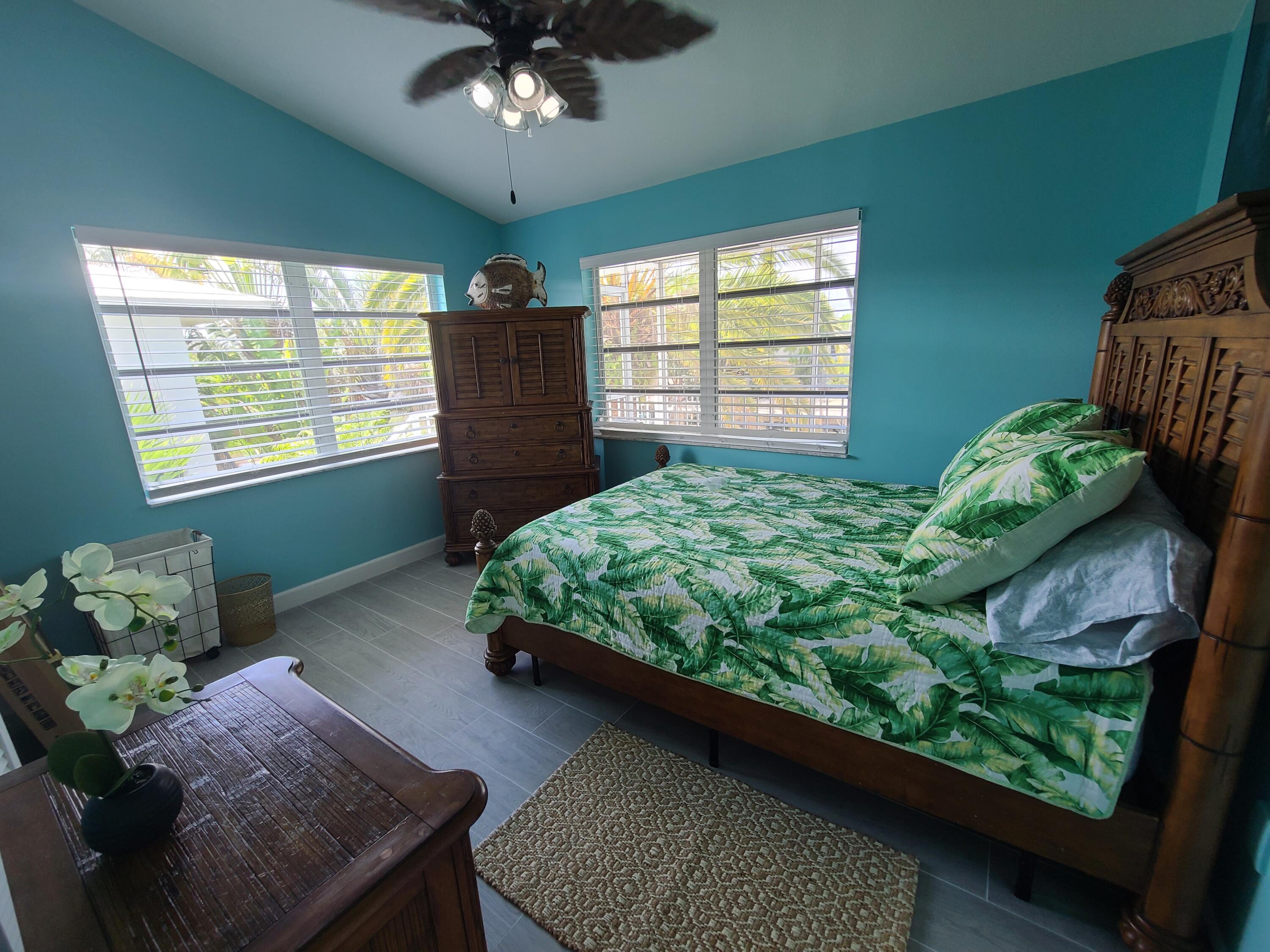 14 South Exuma Road Key Largo, FL 33037 - Photo 16 of 32 a bed sitting in a bedroom next to a window