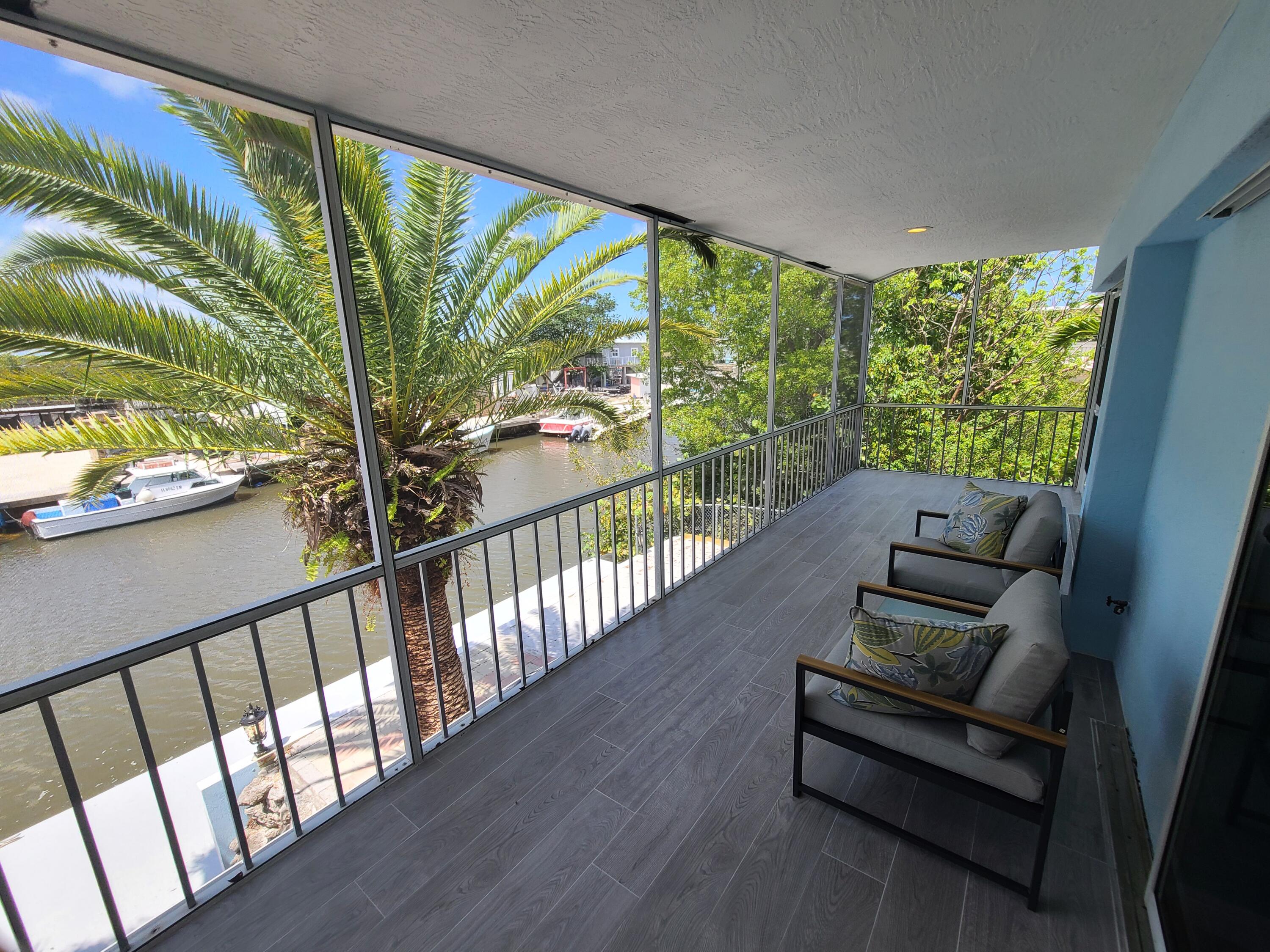 14 South Exuma Road Key Largo, FL 33037 - Photo 27 of 32 a view of a floor to ceiling window with wooden floor