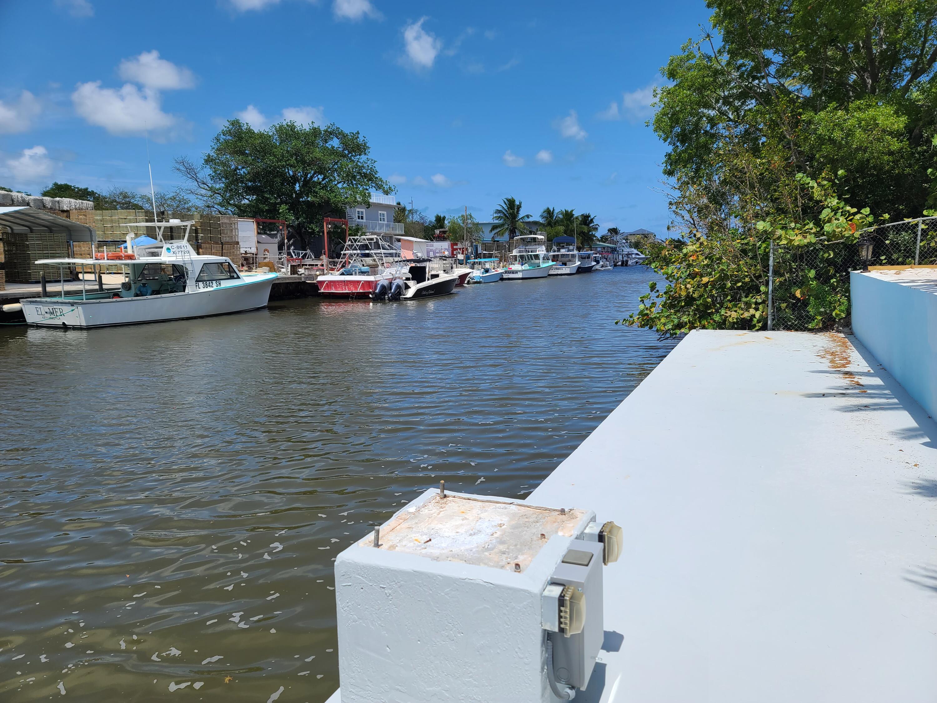 14 South Exuma Road Key Largo, FL 33037 - Photo 32 of 32 a view of a lake with boats and trees in the background