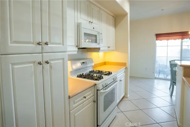 a kitchen with a stove a refrigerator and cabinets