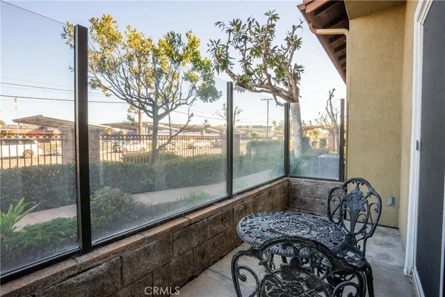 a view of a porch with furniture and floor to ceiling window