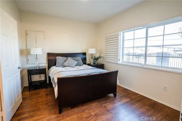 a bedroom with a bed and a large window