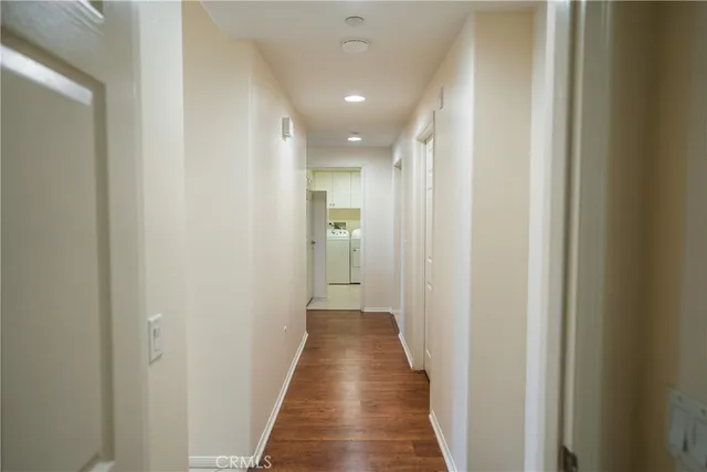 a view of a hallway with wooden floor