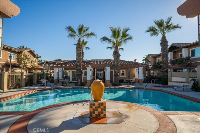a swimming pool with outdoor seating and yard