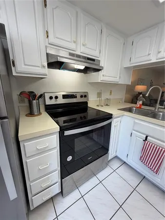 a kitchen with refrigerator and cabinets