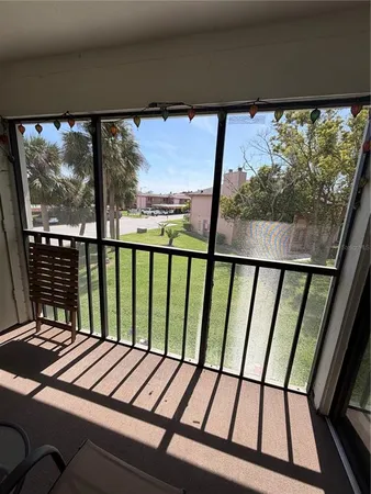 a view of a balcony with furniture and front door