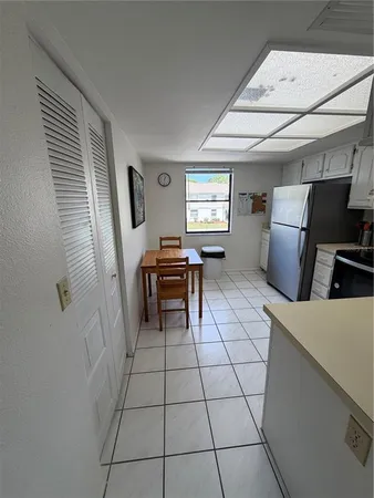 a kitchen with a sink a counter and a stove top oven