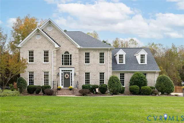 a view of house with yard and green space