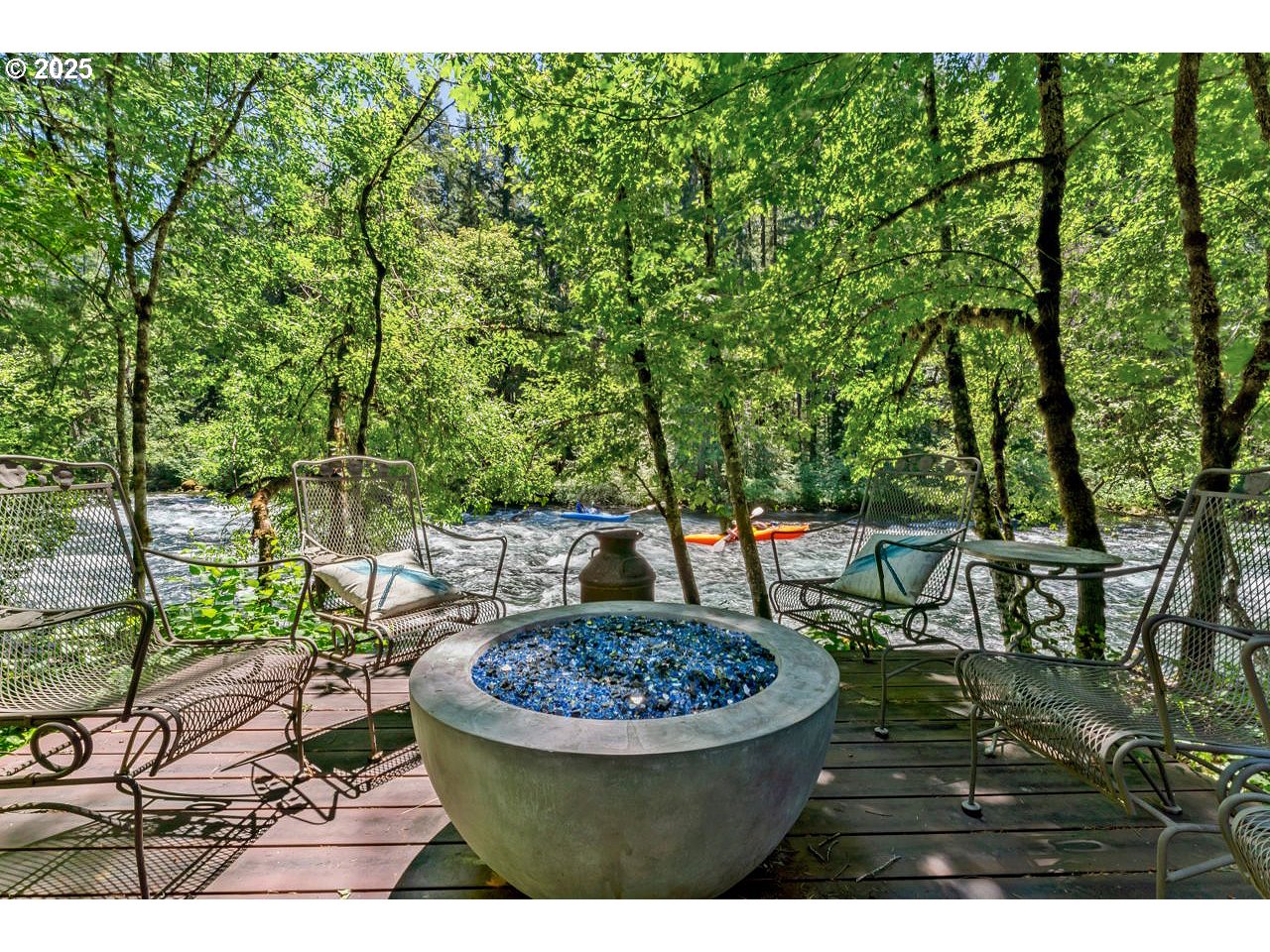 55590 McKenzie River Drive Blue River, OR 97413 - Photo 23 of 45 a view of a chairs and table in the backyard