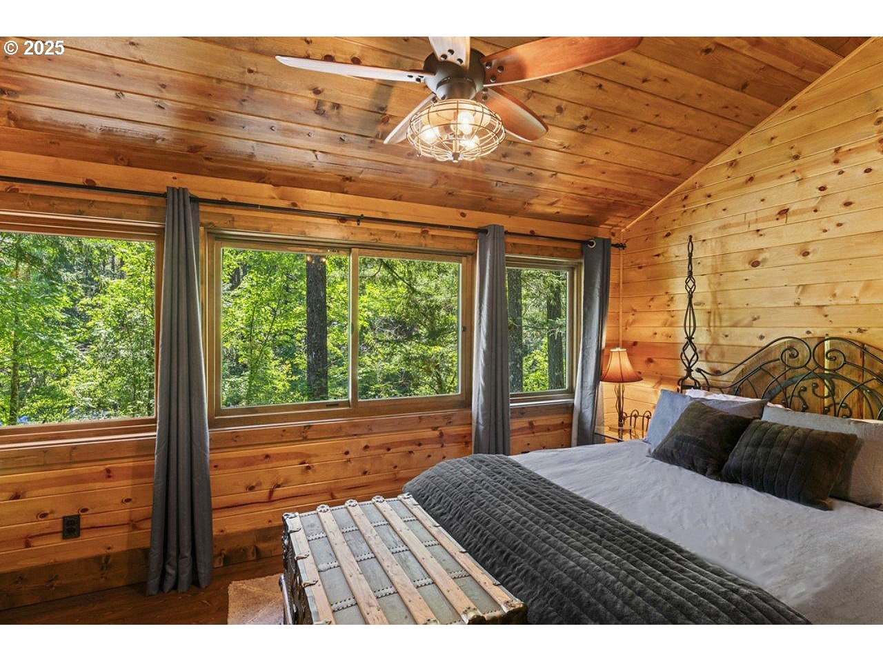 55590 McKenzie River Drive Blue River, OR 97413 - Photo 33 of 45 a bedroom with a bed and wooden floor