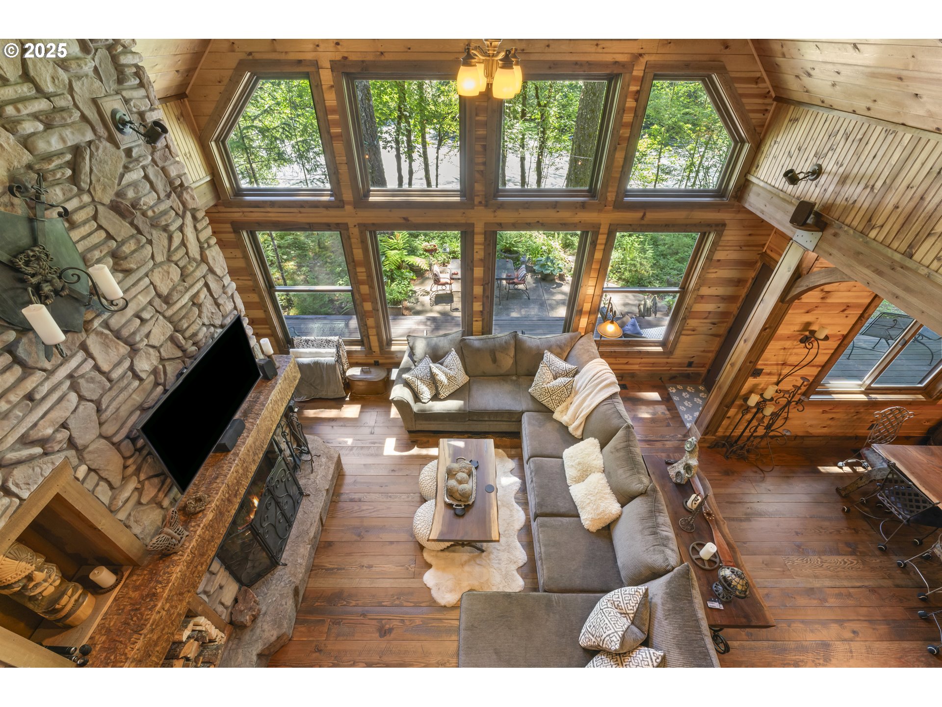 55590 McKenzie River Drive Blue River, OR 97413 - Photo 36 of 45 a living room with furniture and a floor to ceiling window